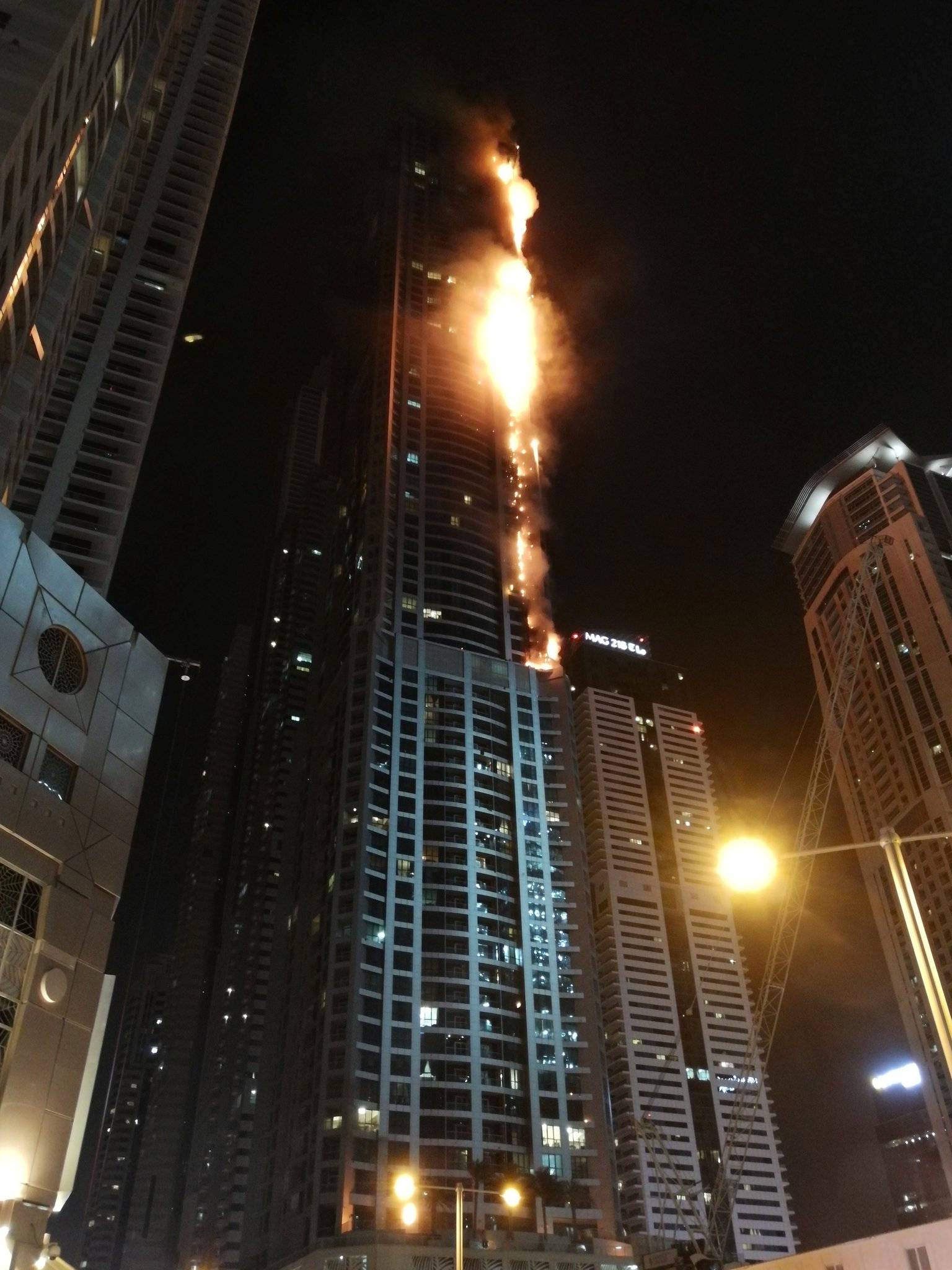 Flames shoot up the sides of the Torch tower residential building in the Marina district, Dubai, United Arab Emirates in this picture by Mitch Williams