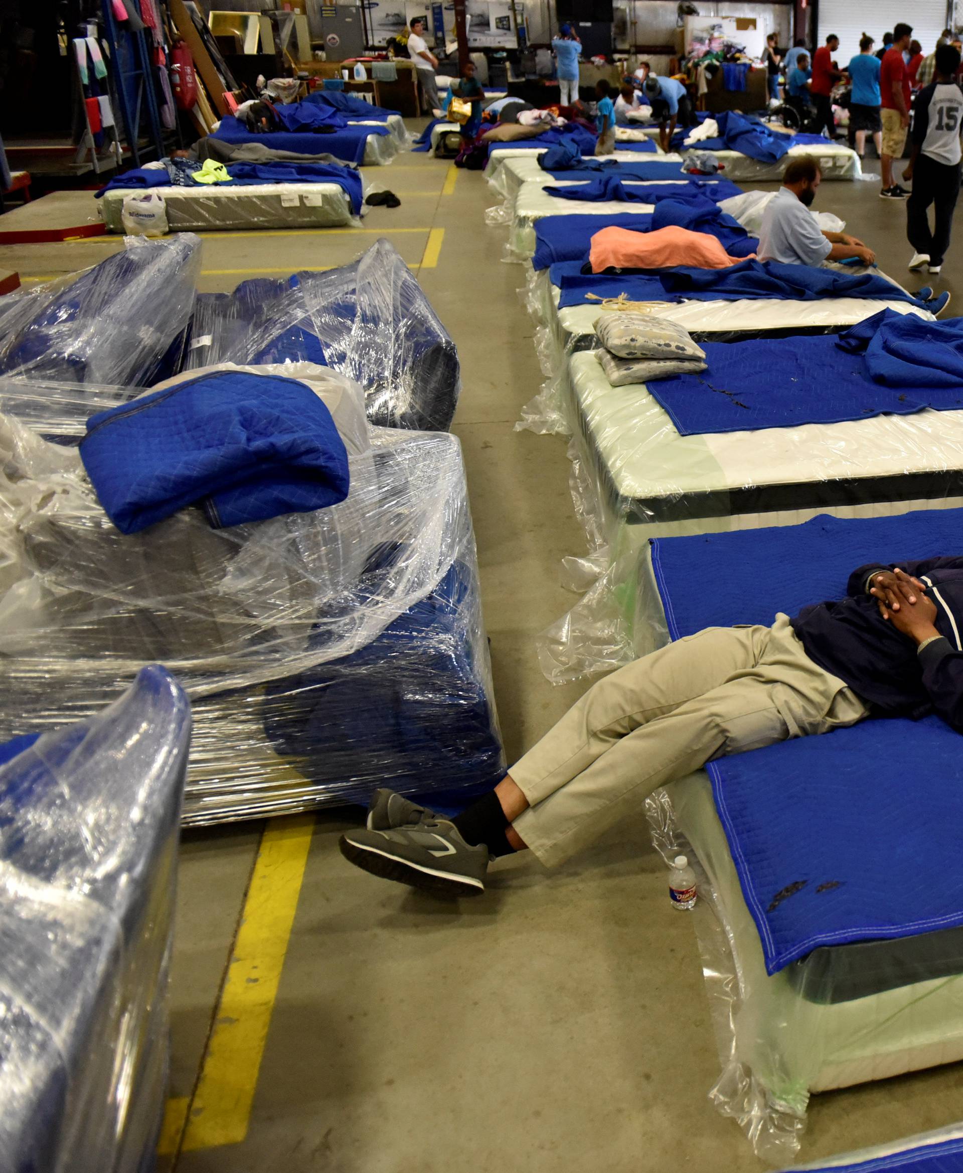 Evacuees get some rest in the warehouse at Gallery Furniture in Houston