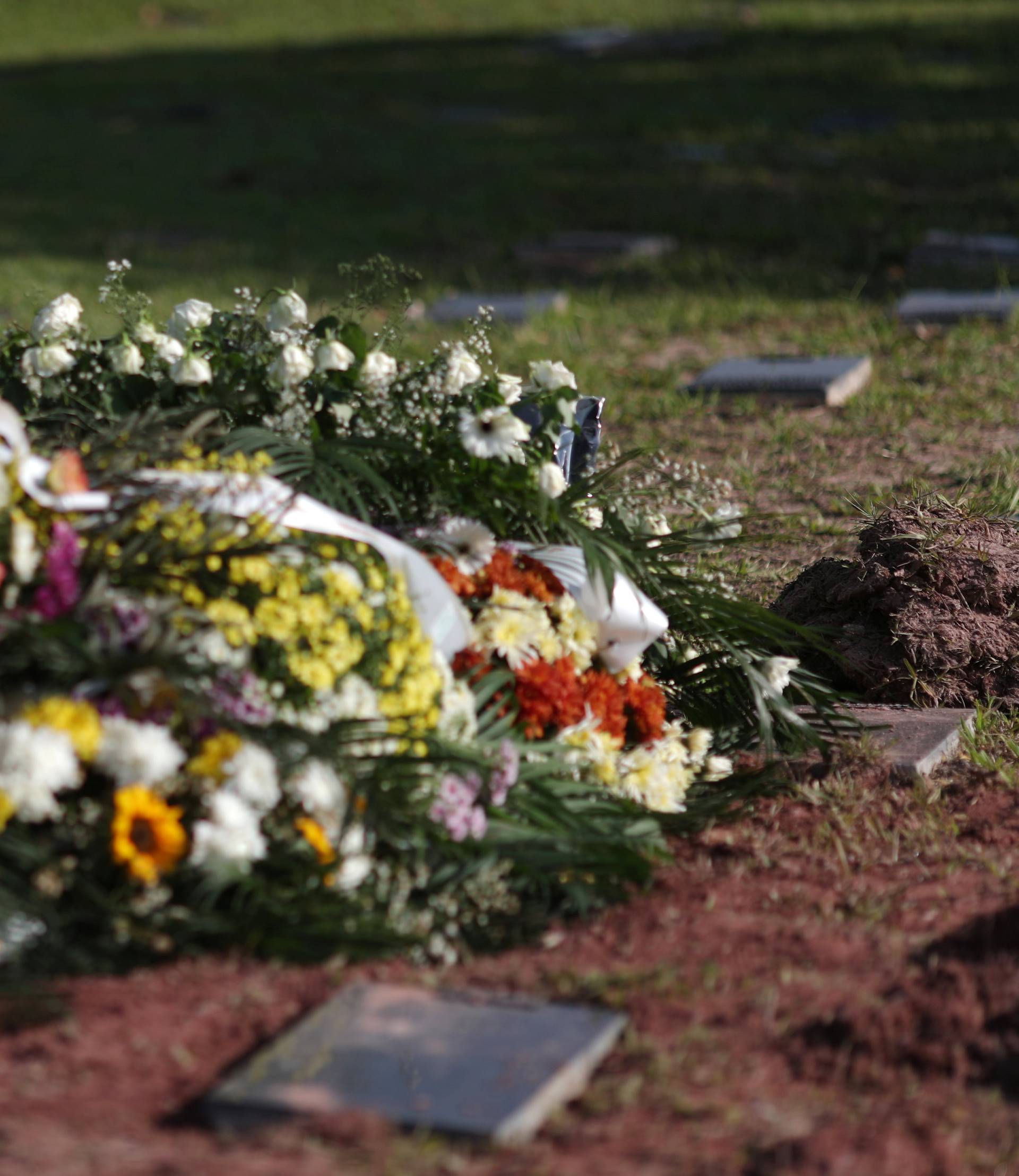 A friend of soccer player Vinicius de Barros Silva Freitas reacts during his burial, after a deadly fire at Flamengo soccer club's training center, in Volta Redonda