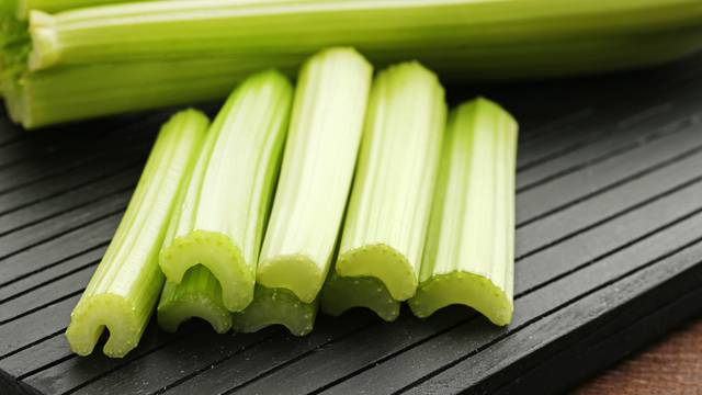 Celery on black cutting board