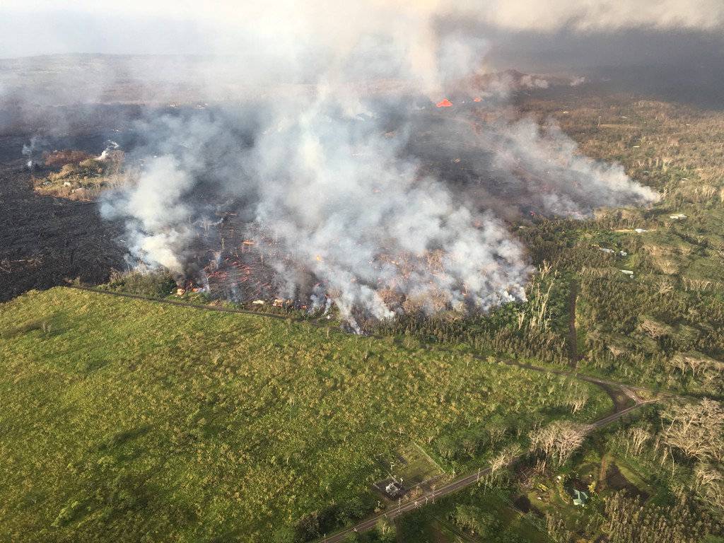 An aerial view shows an active lava flow crossing Pohoiki Road during ongoing eruptions of the Kilauea Volcano in Hawaii