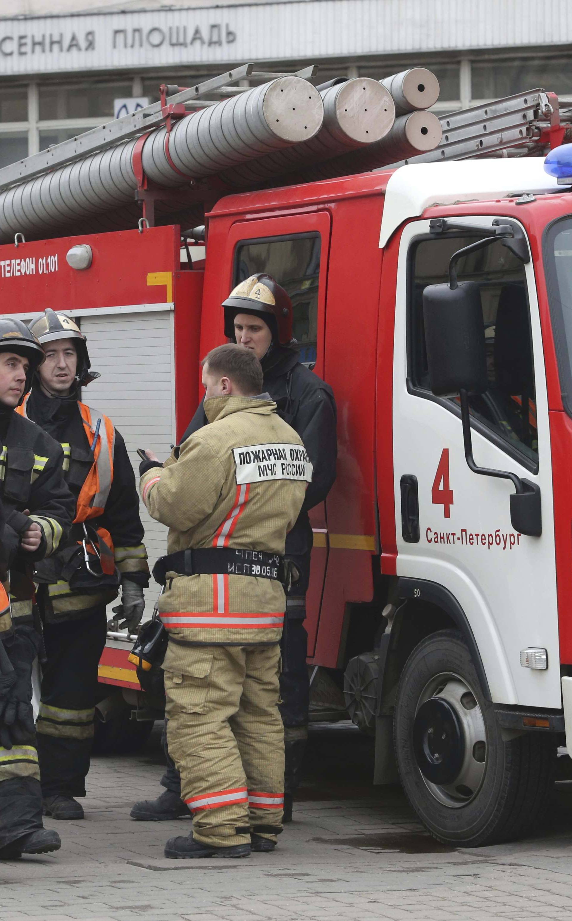 Members of Emergency services stand outside Sennaya Ploshchad metro station in St. Petersburg