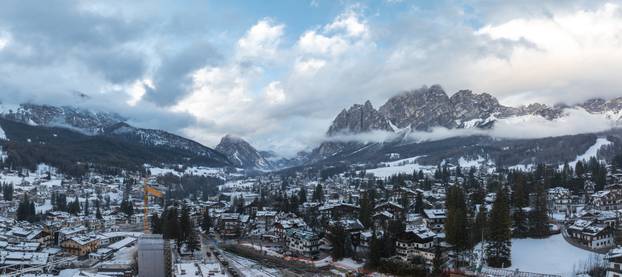 Aerial View of Cortina d'Ampezzo with Snowy Rooftops and Mountains