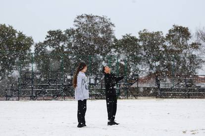 Children play in the snow at Laerskool Orion, a school located in Brackenhurst