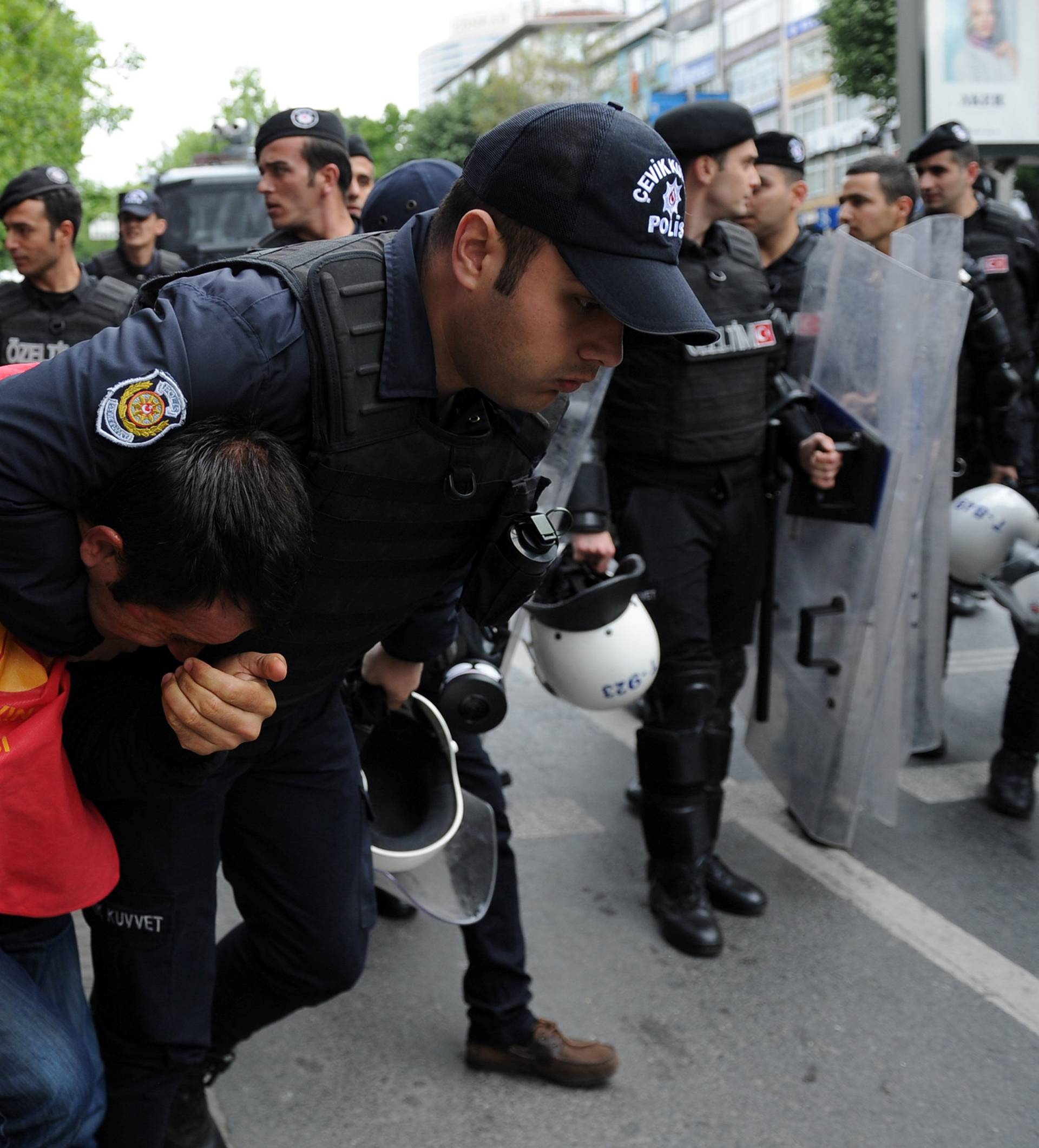 Turkish riot police detain a protester as he and others attempted to defy a ban and march on Taksim Square to celebrate May Day, in Besiktas neighbourhood of Istanbul