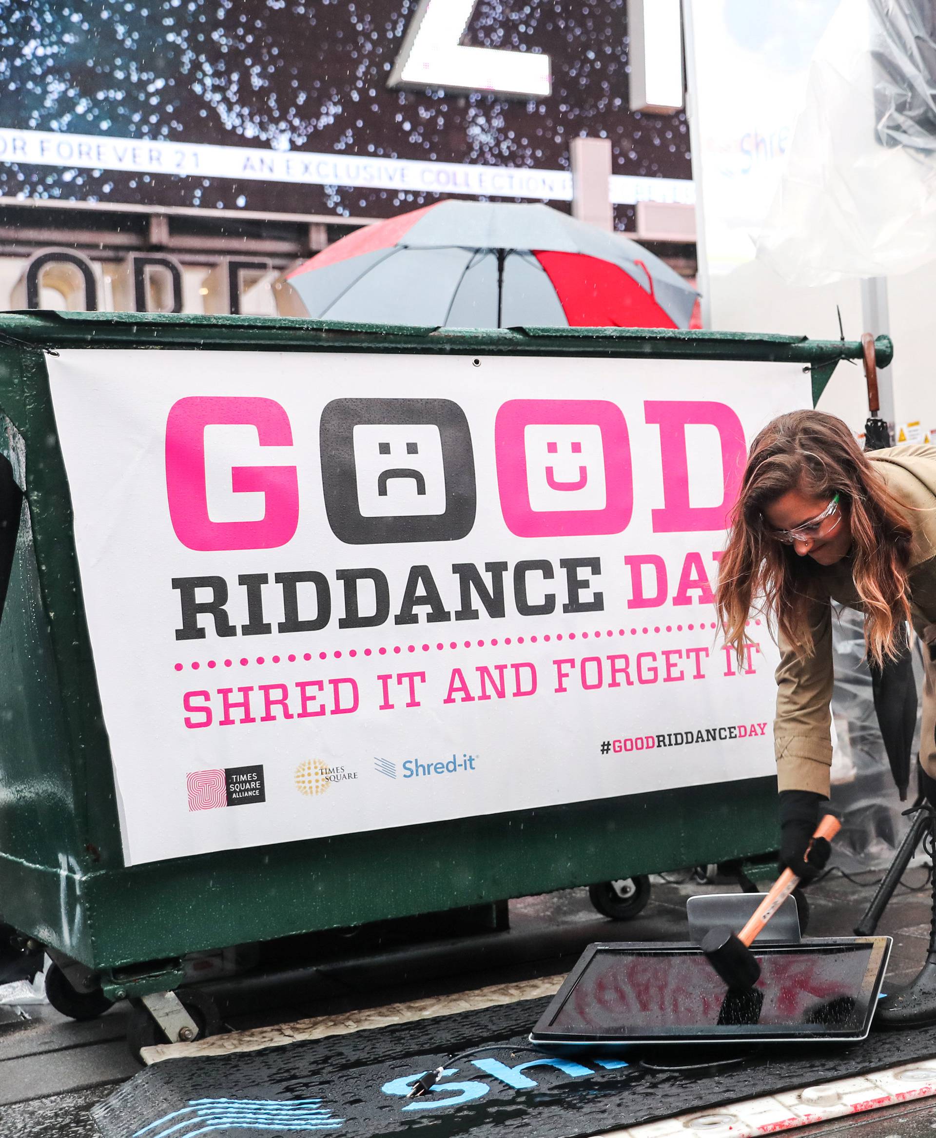 Allison Hagendorf mashes computer parts with a hammer during the National Good Riddance day ceremonial shredding of bad memories of 2018 in Times Square