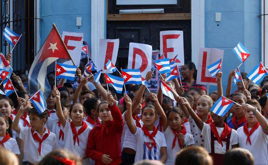 Children perform an act in a school to commemorate the first anniversary of the death of Cuba's late president Fidel Castro, in Havana