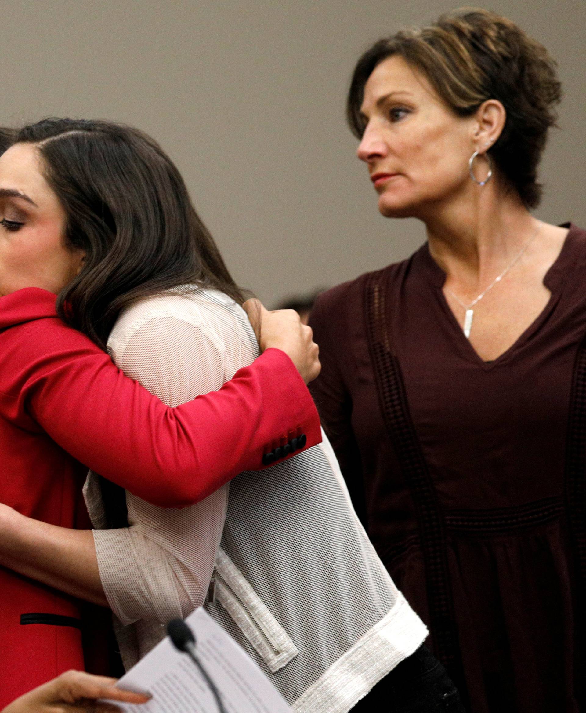 Victim and Olympic gold medalist Aly Raisman embraces former USA teammate Jordyn Wieber at the sentencing hearing for Larry Nassar, a former team USA Gymnastics doctor who pleaded guilty in November 2017 to sexual assault charges, in Lansing