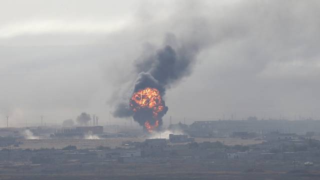 Explosion is seen over the Syrian town of Ras al-Ain as seen from the Turkish border town of Ceylanpinar