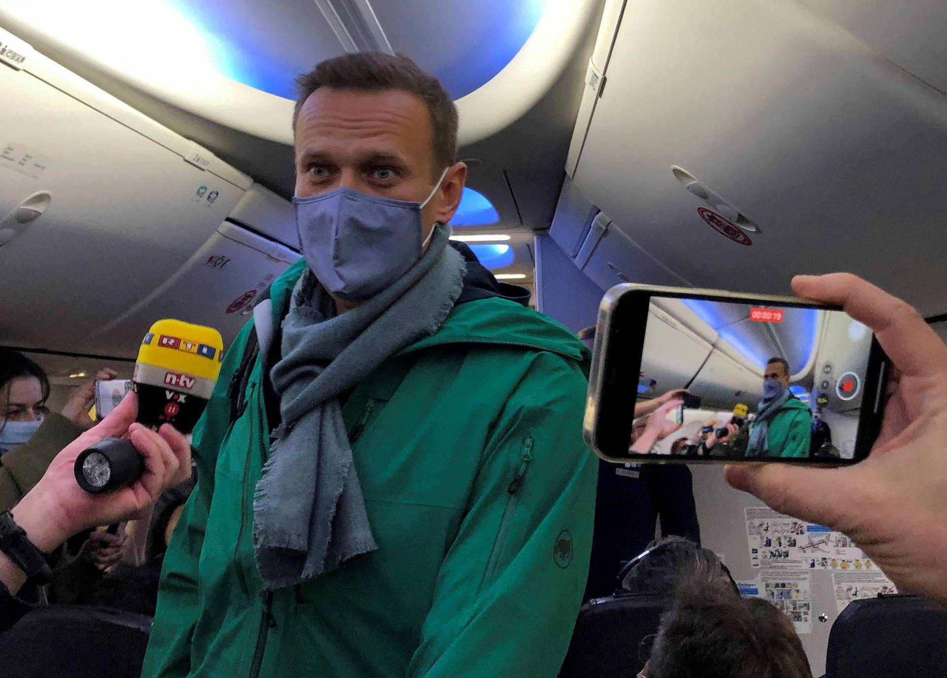 FILE PHOTO: Russian opposition leader Alexei Navalny is seen on board a plane before the departure for Moscow at an airport in Berlin