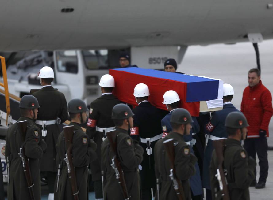Flag-wrapped coffin of late Russian Ambassador to Turkey Karlov is carried to a plane during a ceremony at Esenboga airport in Ankara