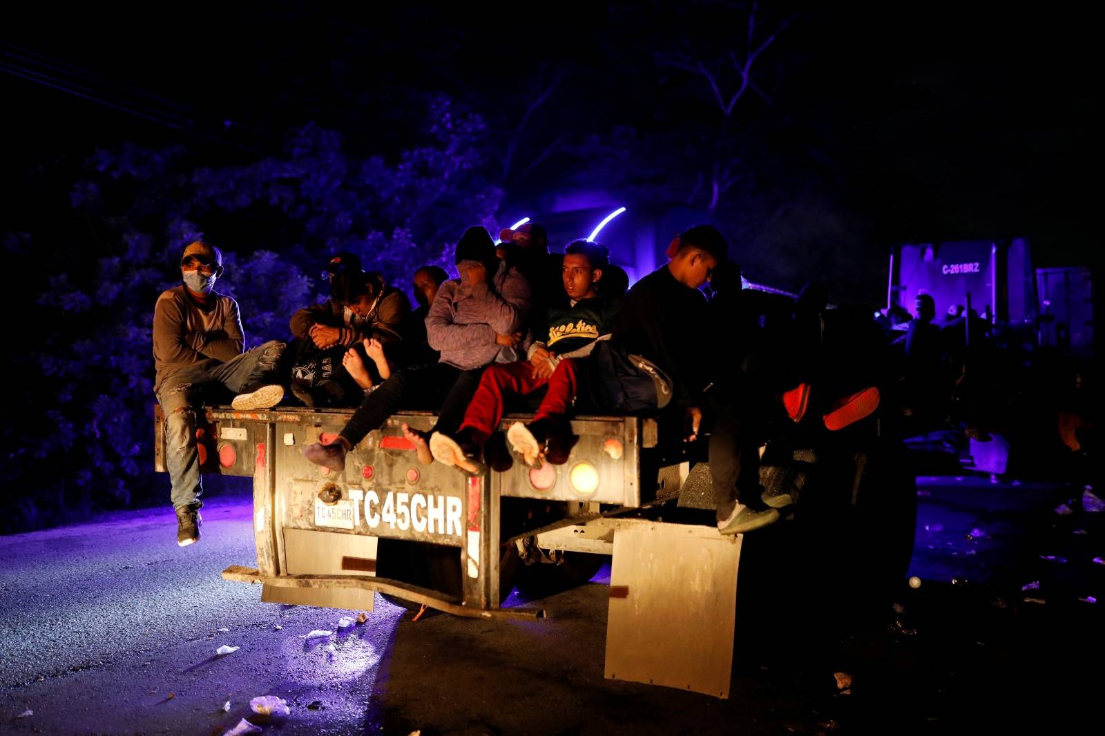 Honduran migrants trying to reach the U.S. hitchhike on a truck, through Izabal department