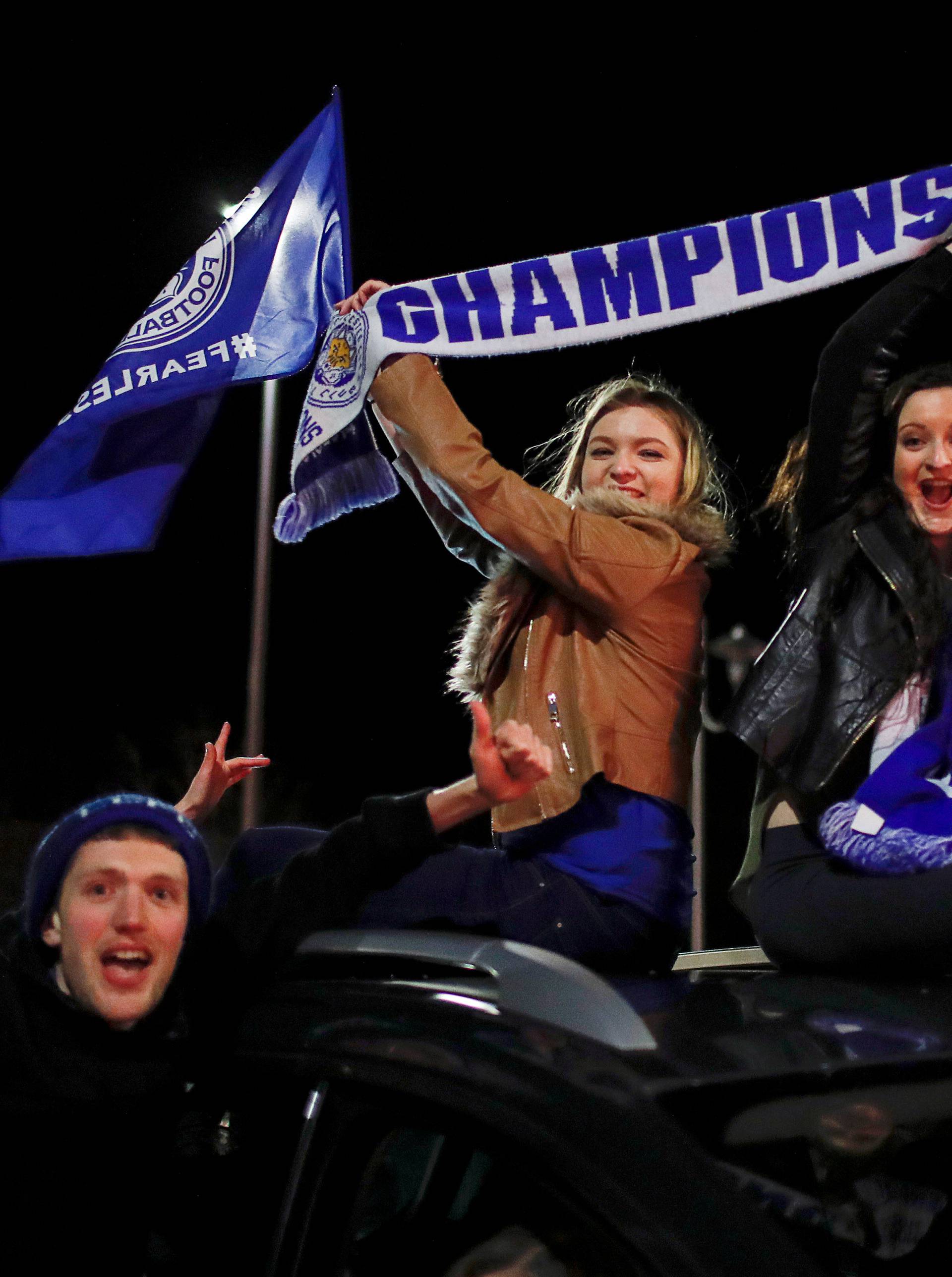 Leicester City fans celebrate outside the King Power stadium after their team won the Premier League title in Leicester