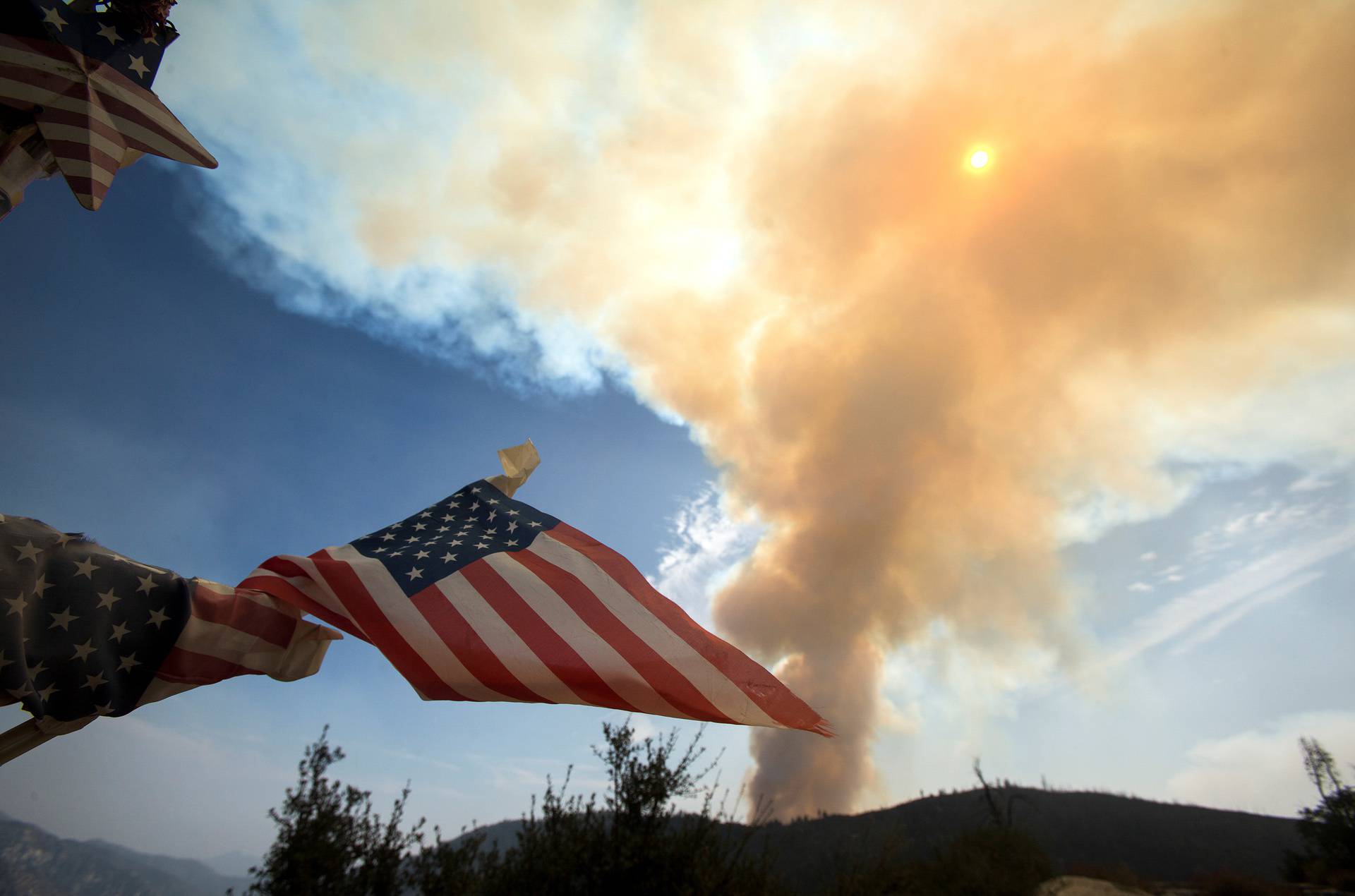 Smoke rises from a wildfire burning in the Angeles National Forest during the Bobcat Fire in Los Angeles