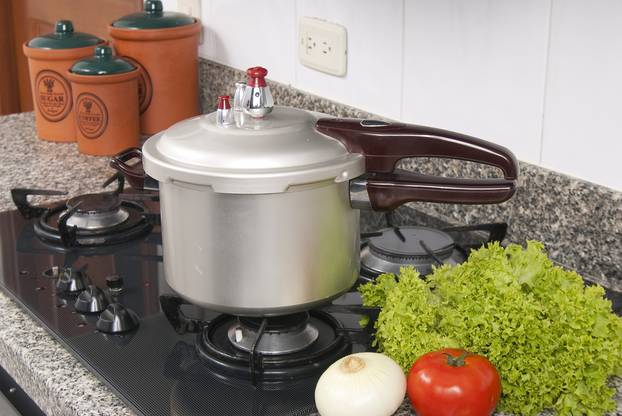 Pressure cooker; photo about stove in the kitchen.