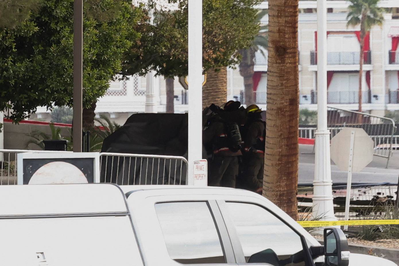 Firefighters work at the Tesla Cybertruck which burned at the entrance of Trump Tower in Las Vegas