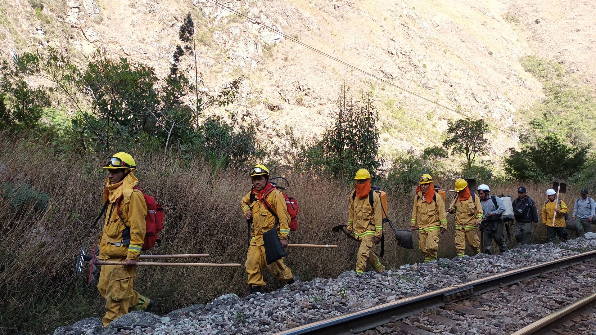 Emergency personnel work to put out a forest fire in Machu Picchu