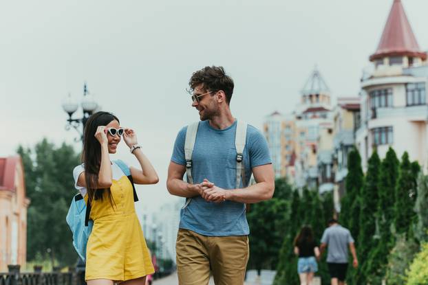 handsome man and asian woman with glasses looking at each other 