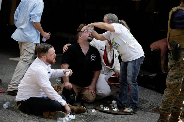 Members of white nationalist protesters receive first-aid during a clash against a group of counter-protesters in Charlottesville