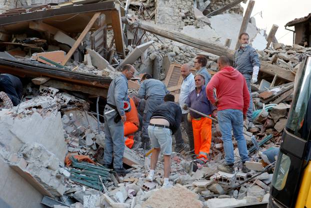 Rescuers works after a quake hit Amatrice 