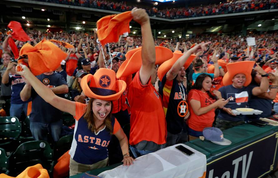 Astros fans watch and cheer as their team plays in Los Angeles during a World Series Game Seven watch party in Houston