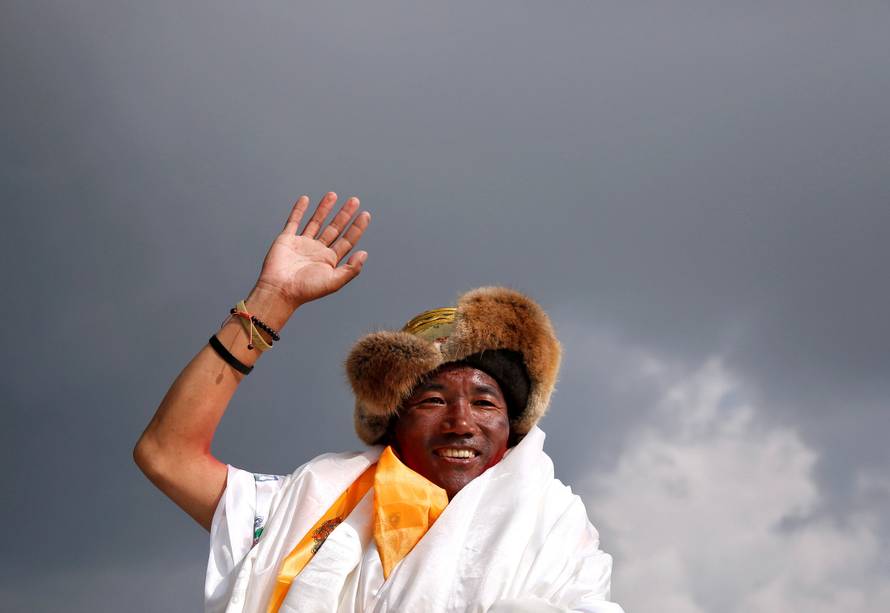 FILE PHOTO: Kami Rita Sherpa, 48, a Nepali mountaineer waves towards the media personnel upon his arrival after climbing Mount Everest for a 22nd time, creating a new record for the most summits of the worldÃs highest mountain, in Kathmandu