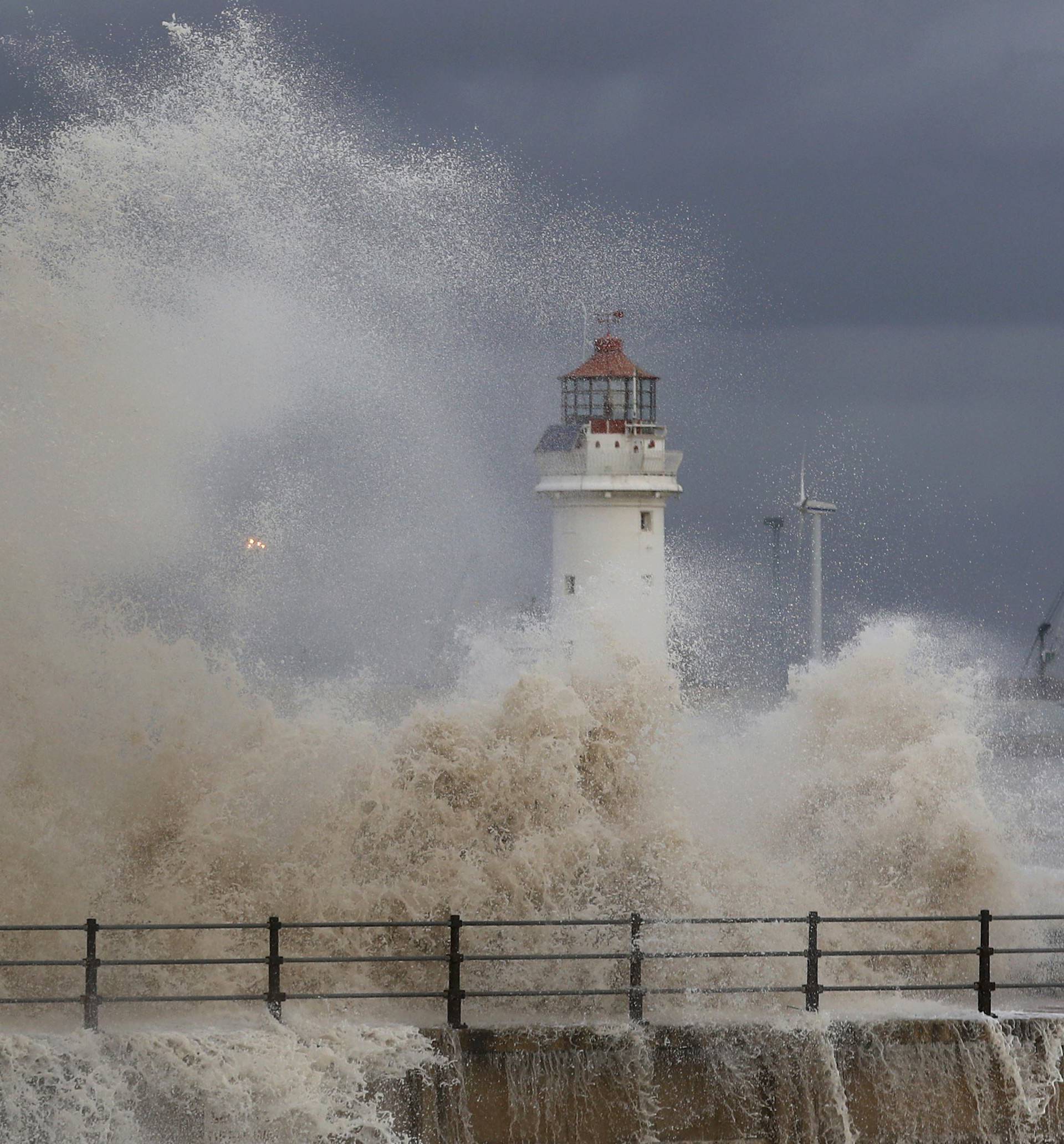 Waves break along the seafront in New Brighton, northern England.
