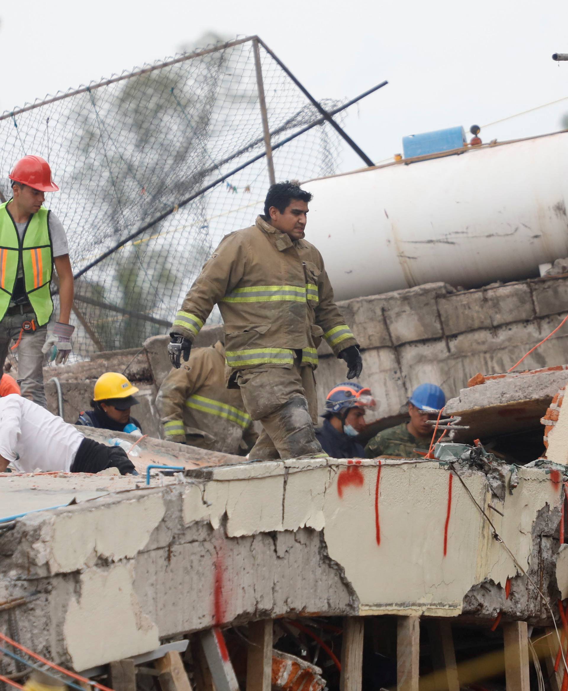 Rescue workers search through the rubble for students at Enrique Rebsamen school after an earthquake in Mexico City