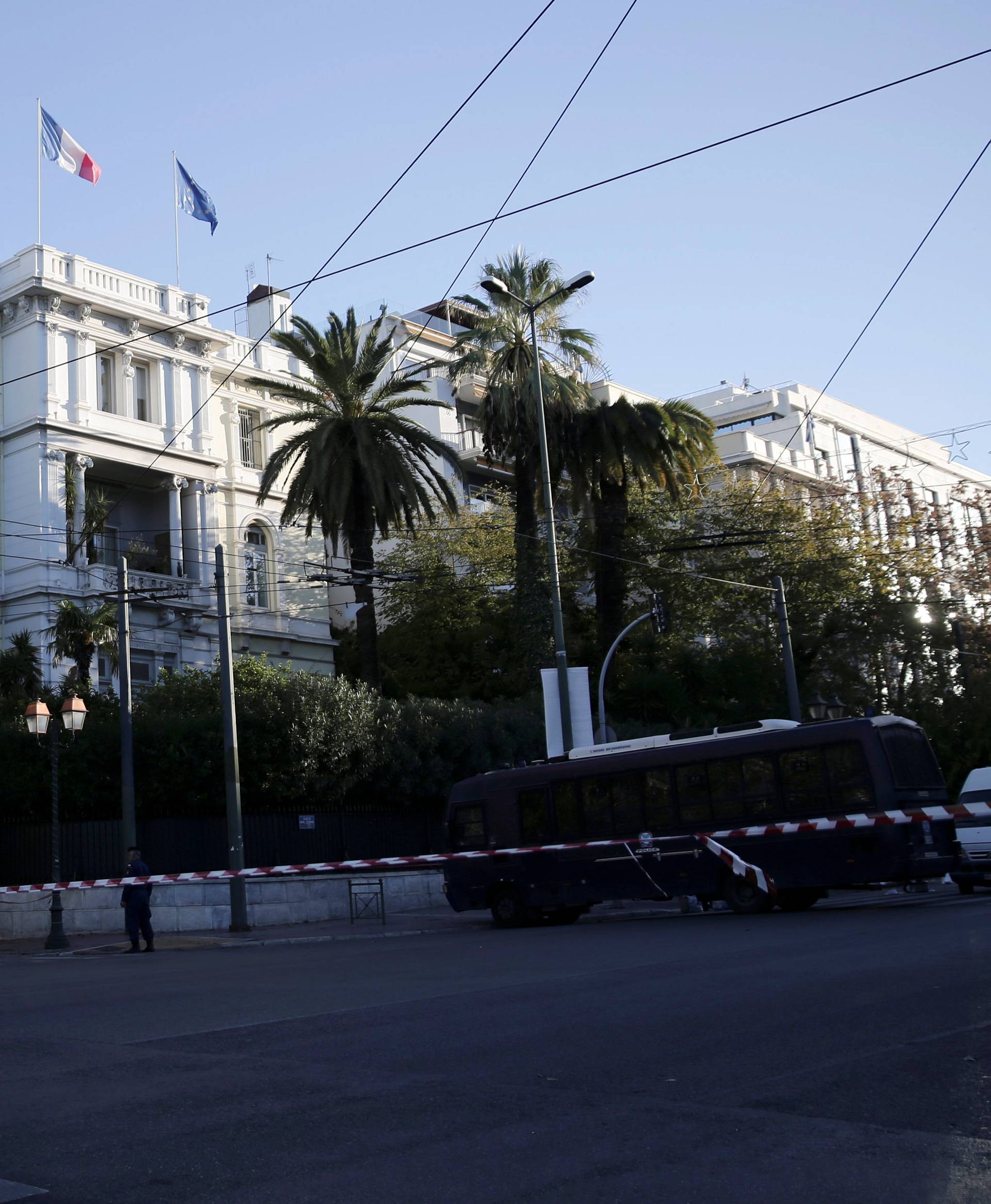 Police stand outside the French embassy, where unidentified attackers threw an explosive device causing a small blast, in Athens