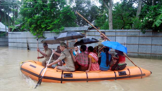 Members of Tripura State Rifles evacuate people from a flooded area after heavy rains in Baldakhal village on the outskirt of Agartala