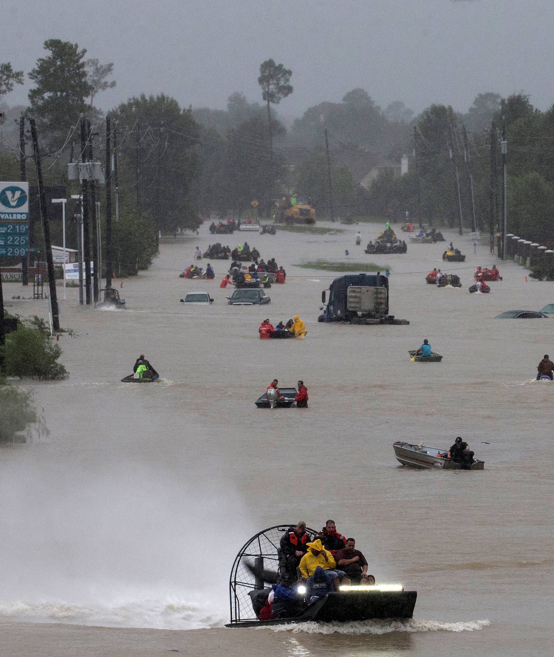 Residents use boats to evacuate flood waters from Tropical Storm Harvey along Tidwell Road east Houston, Texas