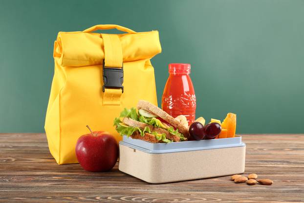 Lunch,Box,With,Appetizing,Food,And,Bag,On,Wooden,Table