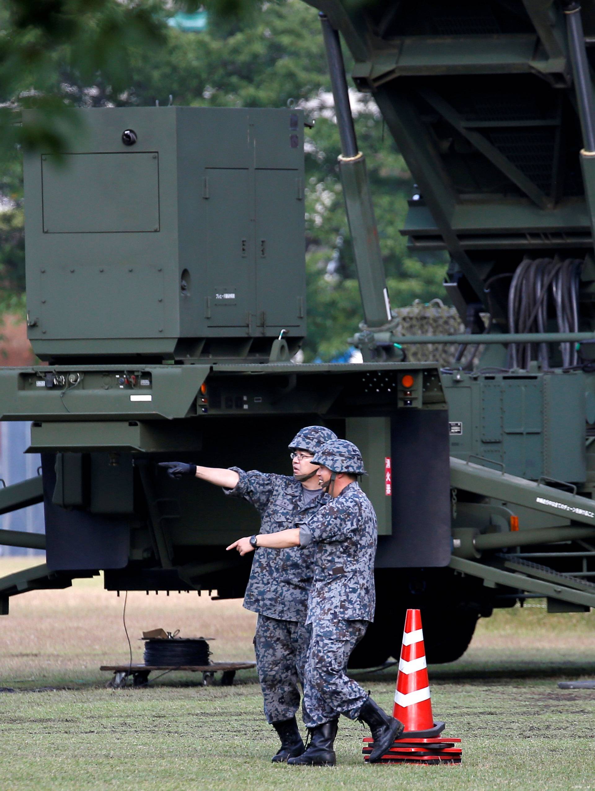 Japan Self-Defense Forces soldiers are seen next to unit of Patriot Advanced Capability-3 (PAC-3) missiles at the Defense Ministry in Tokyo, Japan