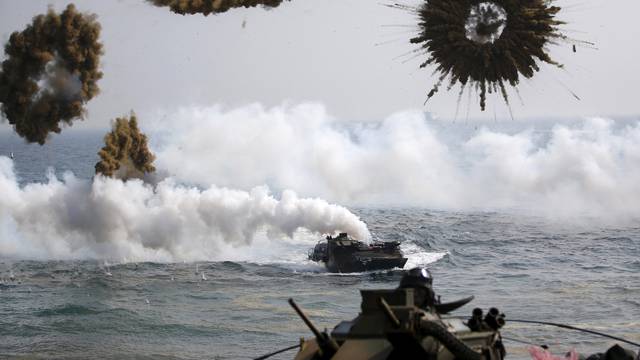 FILE PHOTO: Amphibious assault vehicles of the South Korean Marine Corps throw smoke bombs as they move to land on shore during a U.S.-South Korea joint landing operation drill in Pohang
