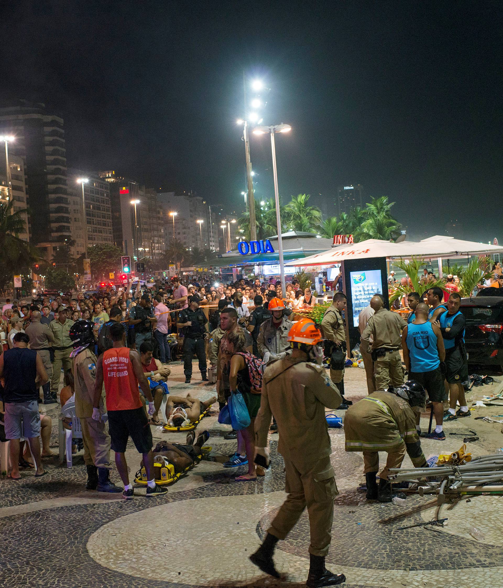 Paramedics help the injured after a vehicle ran over some people at Copacabana beach in Rio de Janeiro