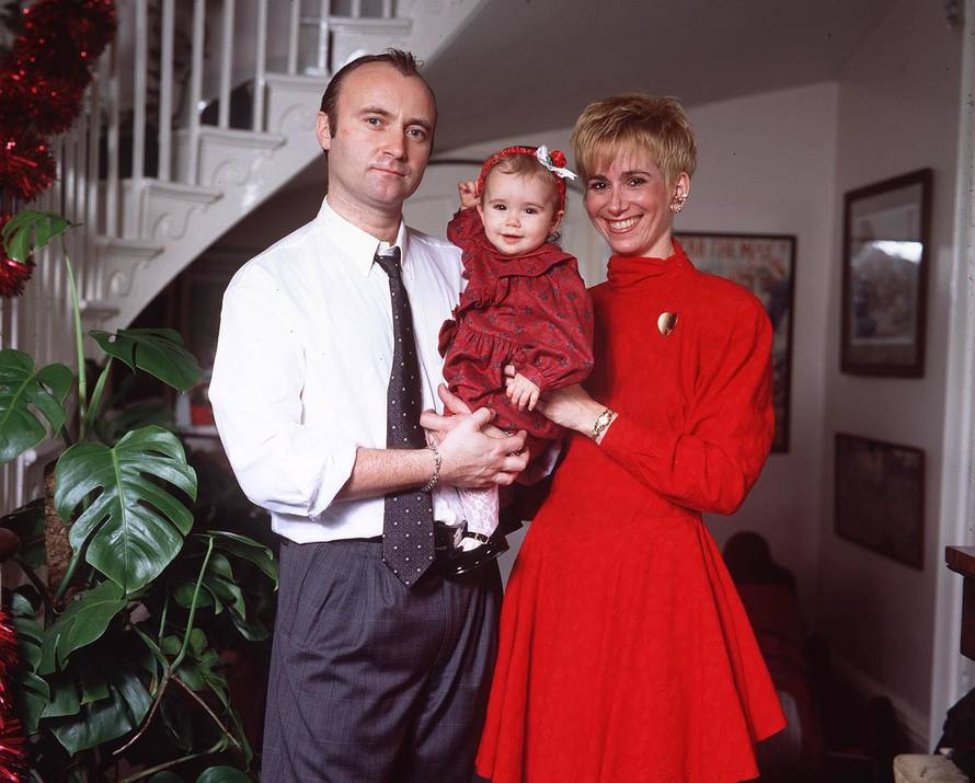 PHIL COLLINS WITH HIS WIFE, JILL AT THEIR DAUGHTER LILY'S CHRISTENING