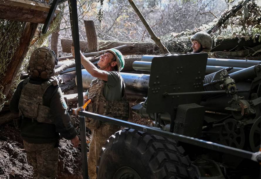 Ukrainian servicemen fire a self-propelled howitzer towards Russian troops near the frontline town of Pokrovsk