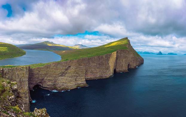 Huge cliff and lake Sorvagsvatn on island of Vagar, Faroe Islands, Denmark.