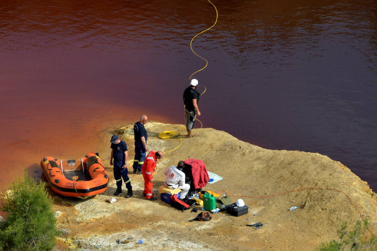 Forensics officers search Kokkinopezoula lake, also known as "red lake", for possible bodies of victims of a suspected serial killer near the village of Mitsero