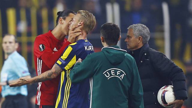 Manchester United's Zlatan Ibrahimovic clashes with Fenerbahce's Simon Kjaer as manager Jose Mourinho looks on