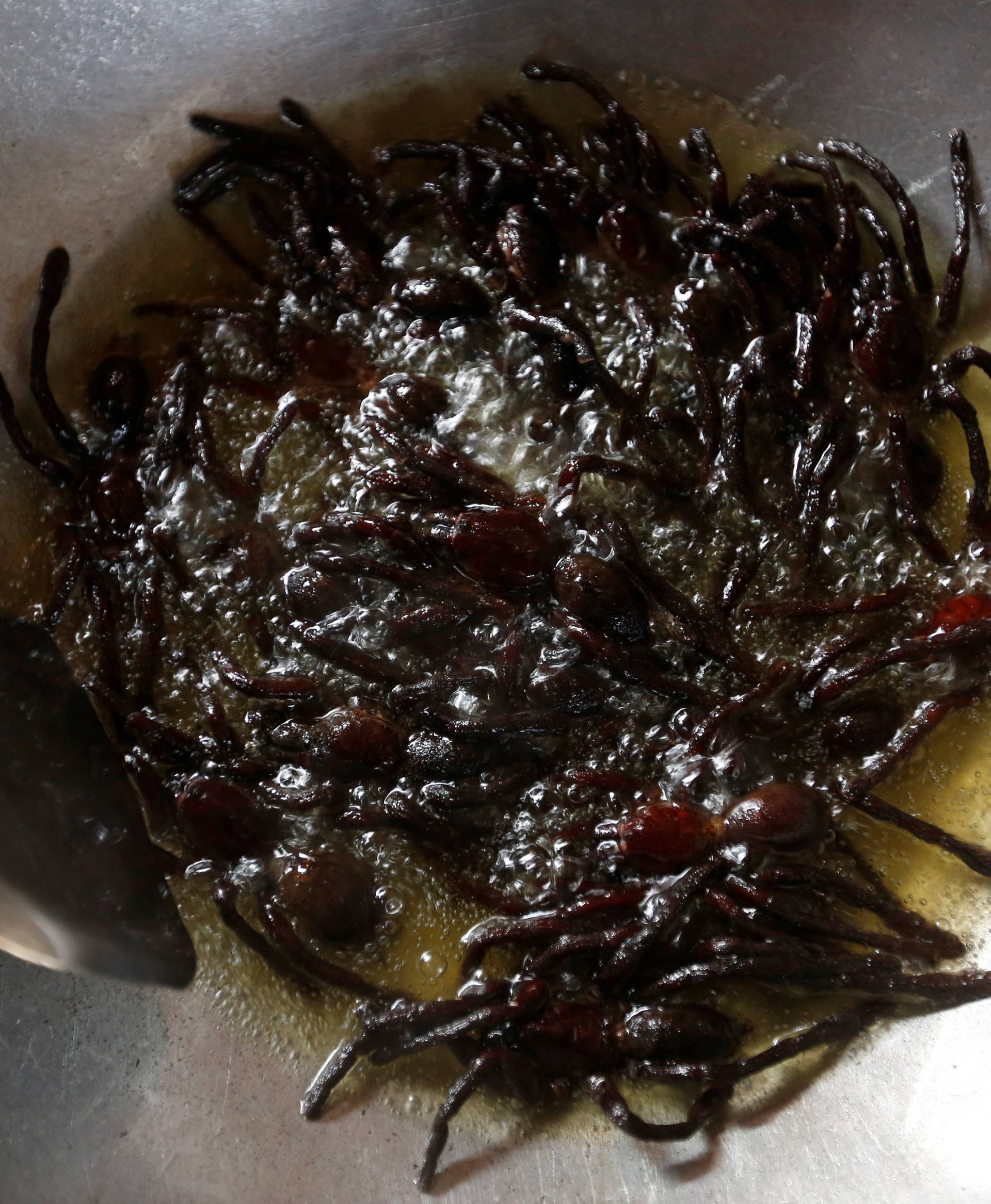 Tarantulas are fried in a pan in Kampong Cham province in Cambodia