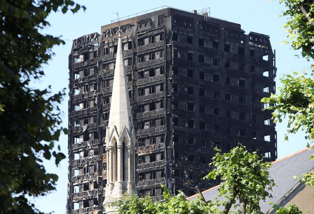 A church spire stands in the foreground of Grenfell Tower in North Kensington, London