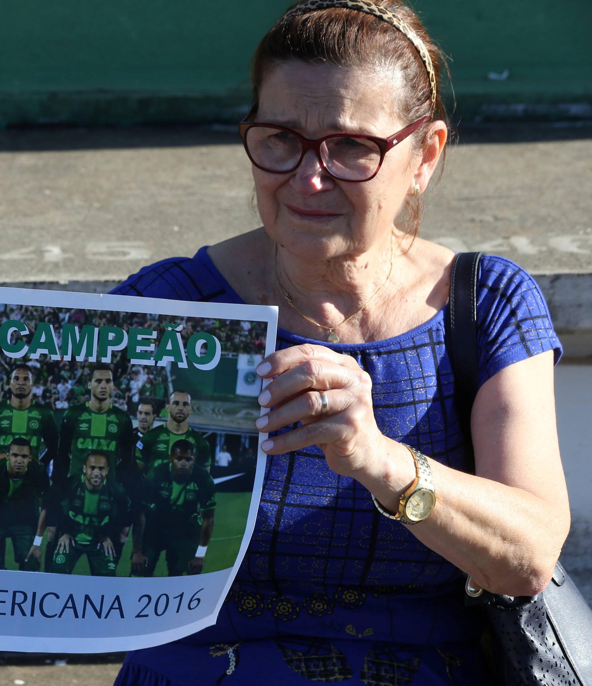 A fan of Chapecoense soccer team shows a poster of her team at the Arena Conda stadium in Chapeco