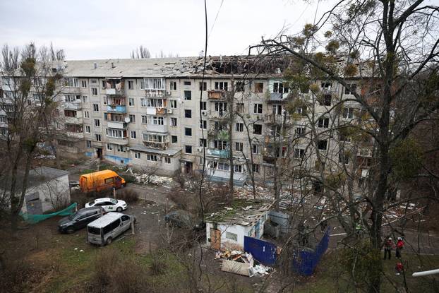 Emergency responders work at the site of a Russian drone strike on an apartment building, in Kyiv