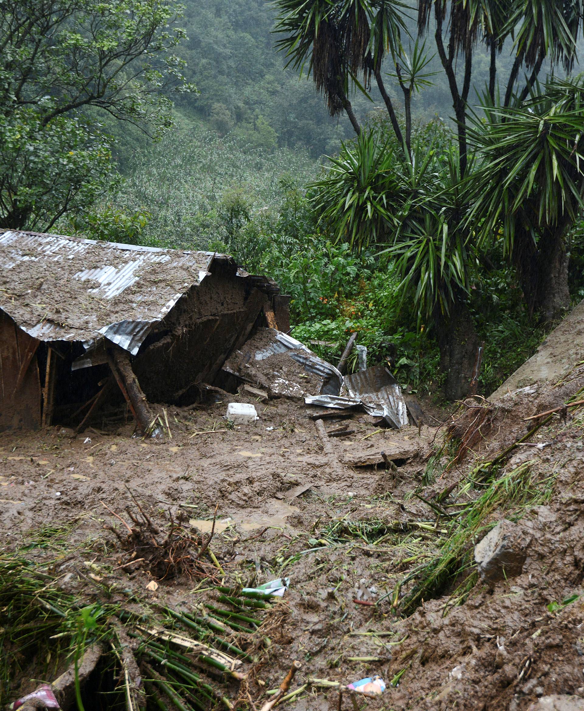 A view of the house where three members of a family died after a mudslide following heavy showers caused by the passing of Tropical Storm Earl in the town of Temazolapa