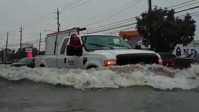 A car passes through a flooded street as storm Imelda hits Houston