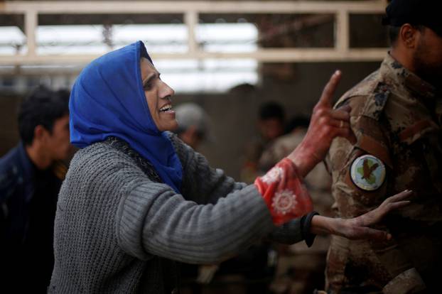 Iraqi woman reacts as she rushes to a field hospital to see her daughters who were wounded during clashes in the Islamic State stronghold of Mosul, in al-Samah neighborhood