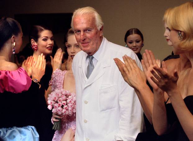 FILE PHOTO: French fashion designer Hubert de Givenchy is applauded by the models after he presented his last High Fashion collection Autumn/Winter 1995 in Paris