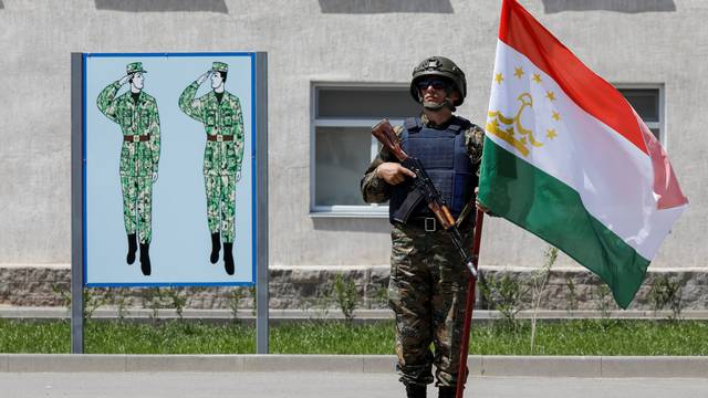 A member of special operations unit stands with a Tajikistan's flag during the Collective Security Treaty Organisation (CSTO) military exercise outside Almaty