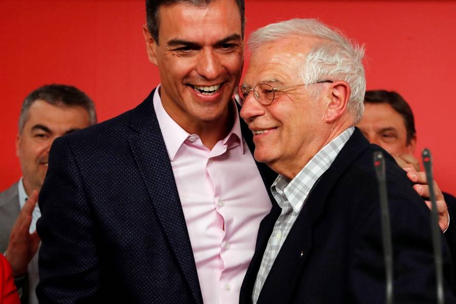 Socialist party (PSOE) candidate for European elections Borrell and Spanish acting PM Sanchez rembrace as they address the media following election results at the party headquarters in Madrid